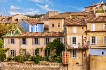 Fototapeta na wymiar Street view of a picturesque residential neighborhood in the lower city area of Vaison-La-Romaine in Provence, France.