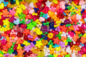 Fototapeta na wymiar A collection of bright and colorful children beads texture background,