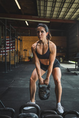 Fototapeta na wymiar young woman exercising in the gym