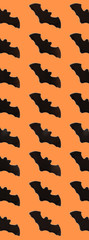 Black Paper Bats on orange background. Halloween concept. Banner for web design. Flat lay, top view, copy space, mockup