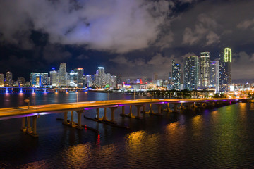 Aerial photo Downotown Miami at night. Bridges over water leading to the city