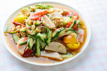 Cucumber salad with preserved pork sausages, Thai popular food called Som Tum Tang, Hot and spicy, mixed vegetables.