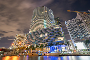 Epic Hotel Downtown Miami with yacht docked. Long exposure to show motion blur in clouds and trees