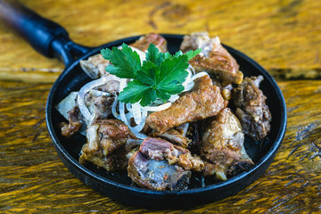 Pork rib served on hot plate, restaurant food.