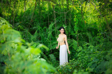 Asian sexy woman wearing a white dress in a mysterious forest, beautiful woman with nature,vine,fern,moss