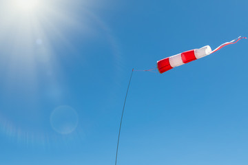 Windsock on a background of blue sky on a sunny day.