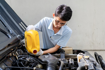 Man refilling the engine oil close up.  Concept of safe driving and automobile care.