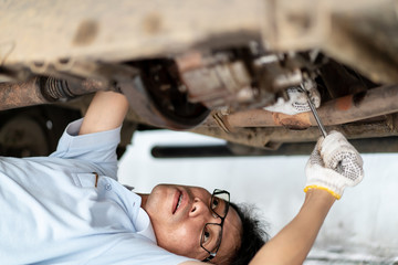 Man repair and maintenance engine of the old car.  Concept of safe driving and automobile care.