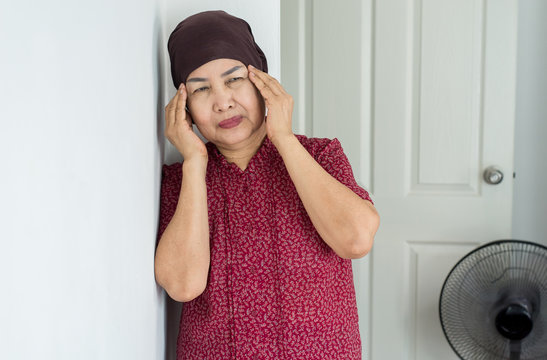 Elderly asian woman depression of lonely have a headache at home,Mental disorder health care,World suicide prevention day concept - Powered by Adobe