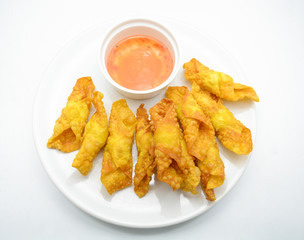 Deep Fried Won ton on white plate with dip source