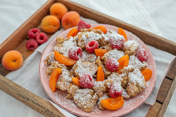 Kaiserschmarrn - traditional austrian pancake dessert with fresh fruit