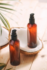 Coconut oil with fresh coconut for alternative therapy on wooden background