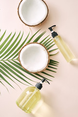 Fototapeta na wymiar Shampoo and spray coconut hair care. Natural cosmetics homemade mask. Coconut oil and scrub. Spa and wellness. Homemade beauty products. Healthy lifestyle.