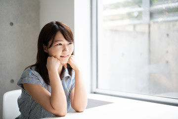 Young woman thinking at home