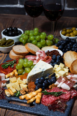 assorted cheeses, fruit and meats to wine, vertical top view