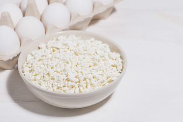 bowl of fresh farm cottage cheese and eggs on a white background