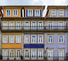Fototapeta na wymiar Facades of traditional houses decorated with ornate Portuguese azulejo tiles in Porto, Portugal
