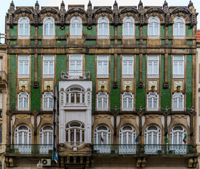 Facades of traditional houses decorated with ornate Portuguese azulejo tiles in Porto, Portugal