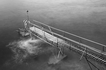 wooden jetty at dusk in black and white