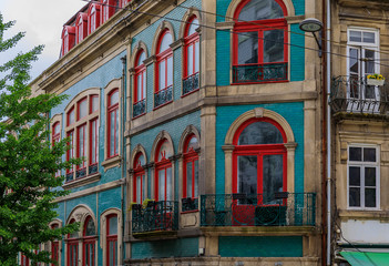 Facades of traditional houses decorated with ornate Portuguese azulejo tiles in Porto, Portugal