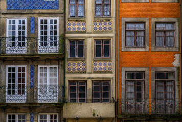 Facades of traditional houses decorated with ornate Portuguese azulejo tiles in Porto, Portugal