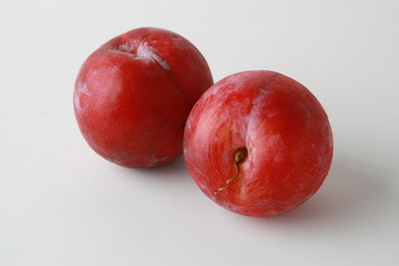 Delicious plums on white background