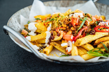 french fries with minced meat, beans and vegetables
