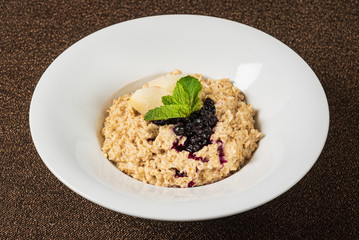 Bowl of oatmeal porridge with berry sauce