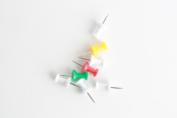 plastic thumbtacks in colorful background