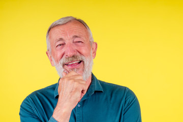 Handsome happy senior expressing positivity and satisfaction,good snow-white teeth.set of false...