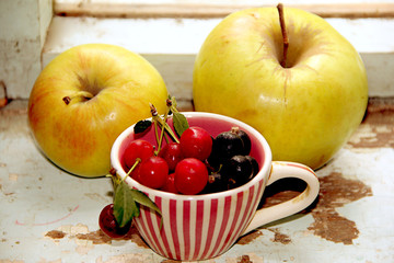 Summer still life of ripe juicy berries and apples