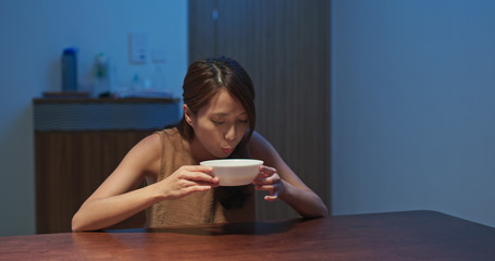 Woman having soup after coming home