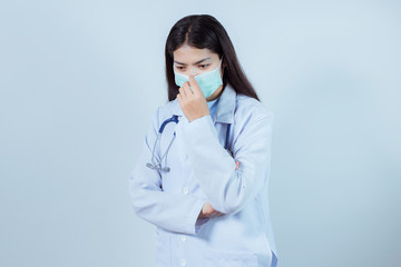 Portrait of young female doctor wearing a mask Shooting in studio. Isolated white background.