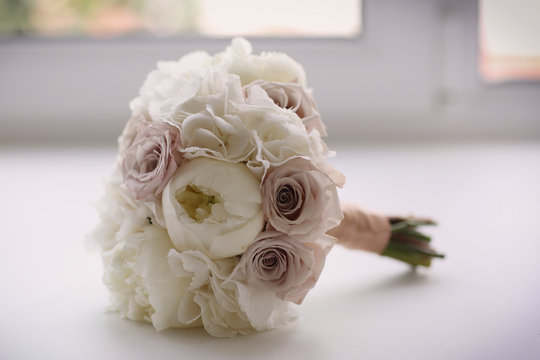 bridal wedding white bouquet with peony white flowers and roses close up photo