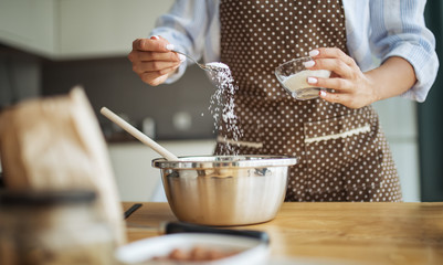 Concept of making a cake. Adding cake preparation ingredients