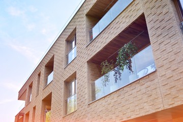 Modern apartment buildings on a sunny day with a blue sky. Facade of a modern apartment building.Glass surface with sunlight.