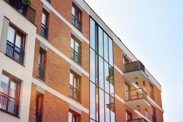 Modern apartment buildings on a sunny day with a blue sky. Facade of a modern apartment building.Glass surface with sunlight.