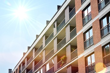 Modern apartment buildings on a sunny day with a blue sky. Facade of a modern apartment building.Glass surface with sunlight.