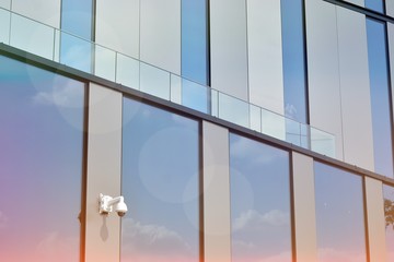 Modern office building detail, glass surface with sunlight