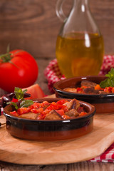 Marinated pork loin in tomato sauce. 