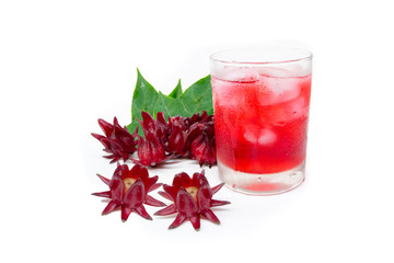 roselle juice (healthy drink) in glass with ice and dried roselle fruit flowers .