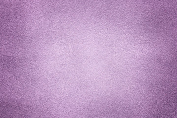 Background of light violet suede fabric closeup. Velvet matt texture of lilac nubuck textile