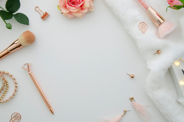 Top view mockup feminine desk workspace with cosmetics and flowers on white background.Flat lay with copy space. Lifestyle concept