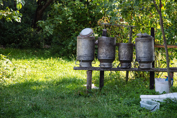 old milk cans hang on the fence