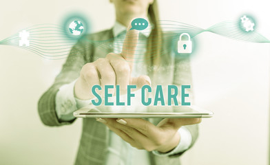 Conceptual hand writing showing Self Care. Concept meaning the practice of taking action to improve one s is own health Female human wear formal work suit presenting smart device