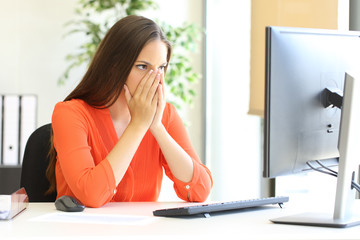 Worried businesswoman discovering mistake on computer