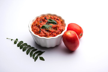 Tomato/tamatar chutney or sauce, served in a bowl. selective focus