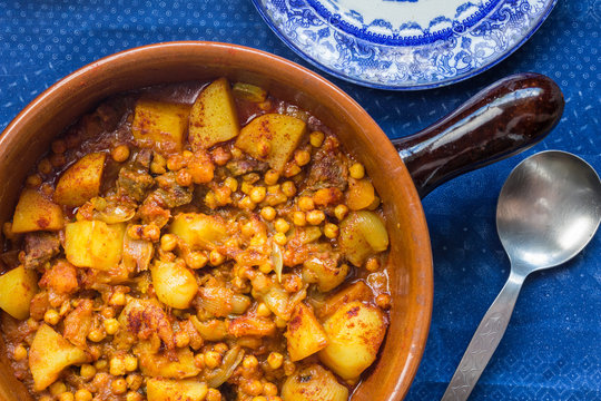 Chick pea, vegetables and meat curry in earthern ware casserole dish
