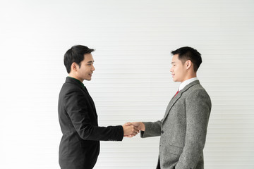 Young asian businessman shakes hands to his partner agrees to cooperate in business. / business concept / cooperate work / successful job.