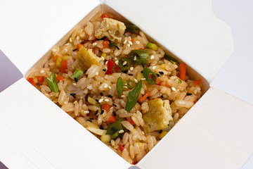 fried rice wok with scrambled eggs and vegetables in a box